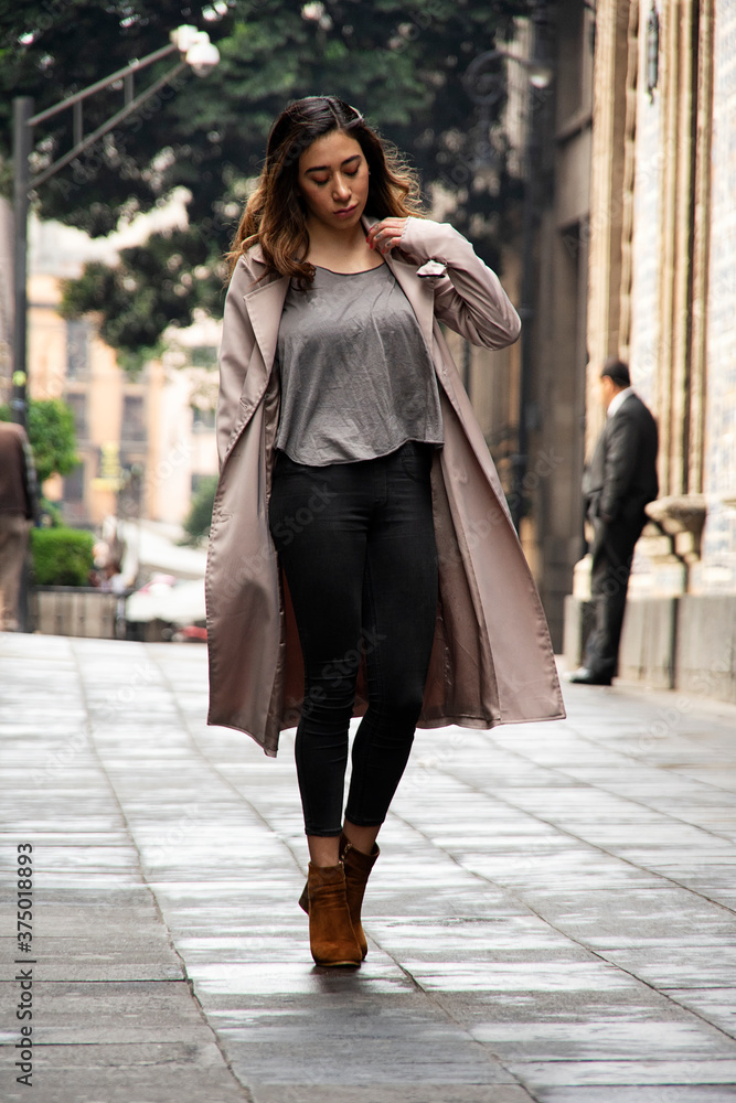 Attractive lady walking in the street in a rainy day Attractive lady walking in the street in a rainy day