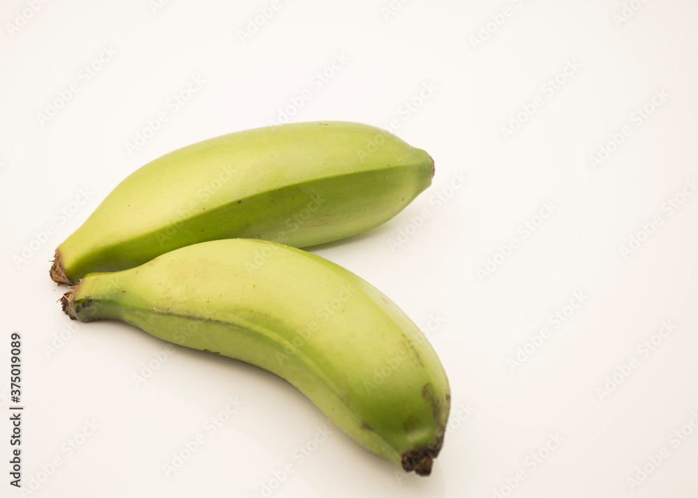 Small green bananas on a white background.