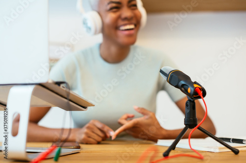 Microphone and laptop near blurred black speaker