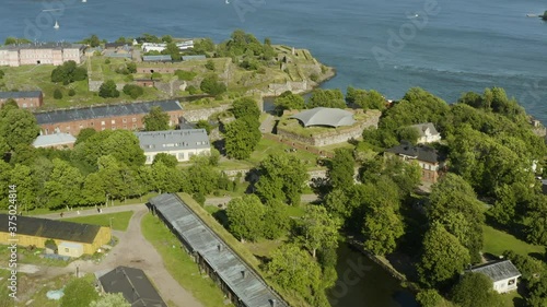 Aerial view over the Suomenlinna fortress island, sunny, summer day, in Helsinki, Finland - reverse, tilt down, drone shot photo