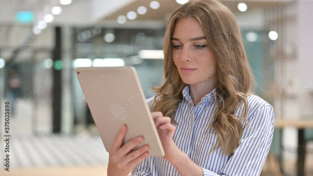 Portrait of Focused Businesswoman using Digital Tablet