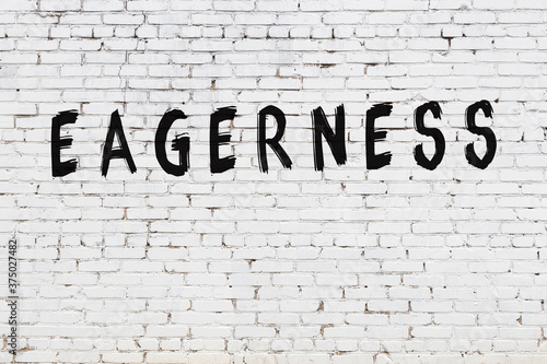 Wall Mural White wall with black paint inscription eagerness on it