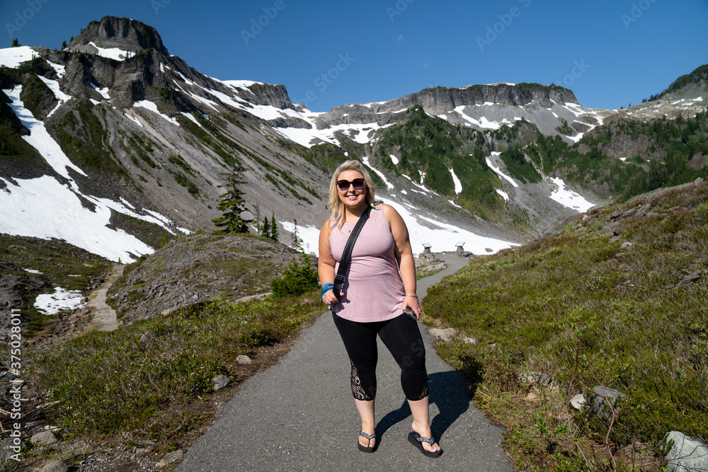 Blonde hiker poses on the Heather Meadows Trail in Mt. Baker National Recreation Area of Washington State