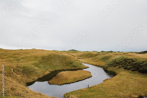 river splits on yellow hills 