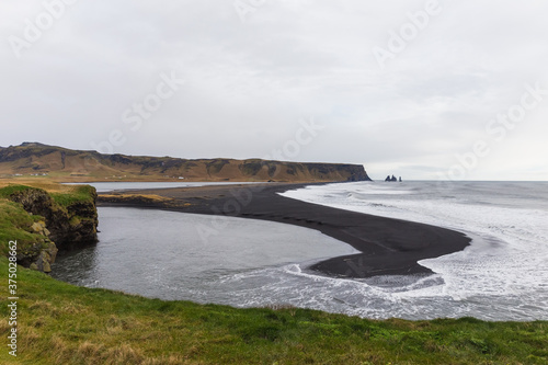 Black sand beach of Reynisfjara viewed from Kirkjufjara Beach, Iceland