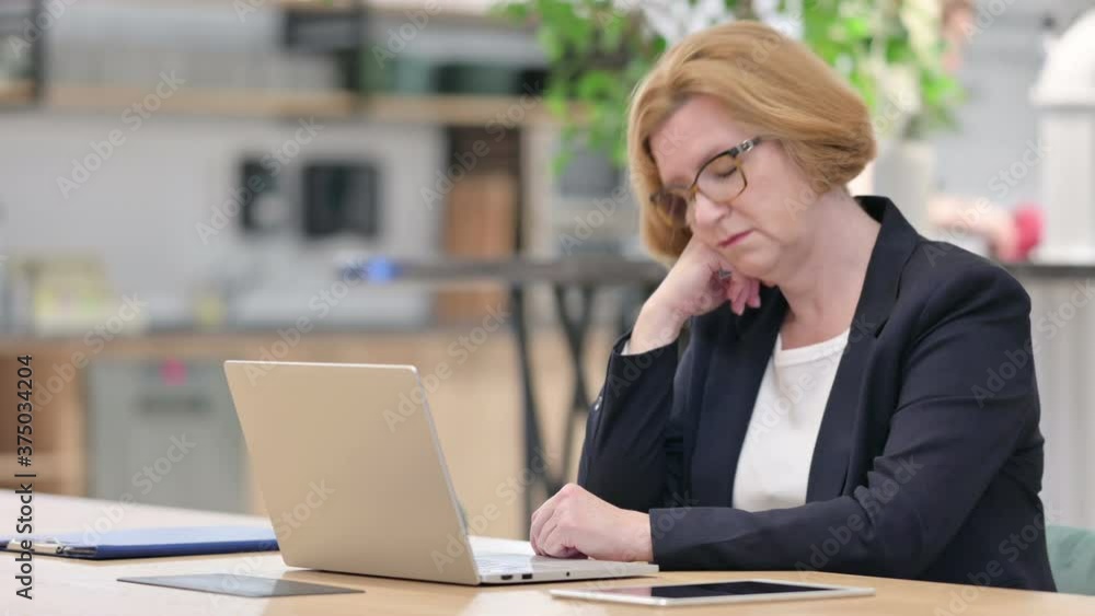 Old Businesswoman with Laptop having Nap in Office Old Businesswoman with Laptop having Nap in Office