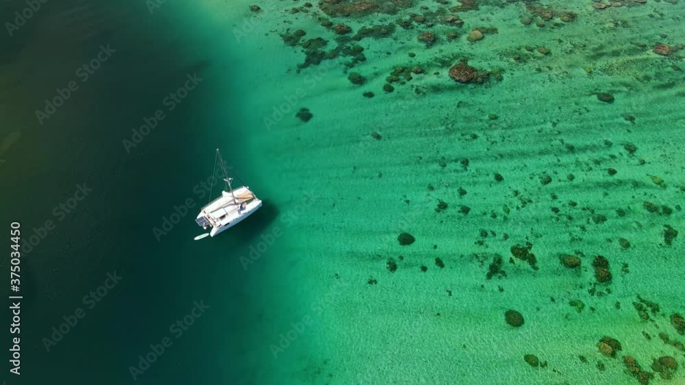 Sailboat in lagoon, Teahupoo, Tahiti. Drone aerial shot. Tropical paradise. French Polynesia 4k. Sailboat in lagoon, Teahupoo, Tahiti. Drone aerial shot. Tropical paradise. French Polynesia 4k.