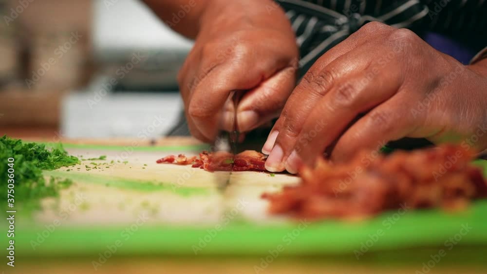 Cutting up fried bacon to add savory bits to a homemade recipe - slow motion Cutting up fried bacon to add savory bits to a homemade recipe - slow motion