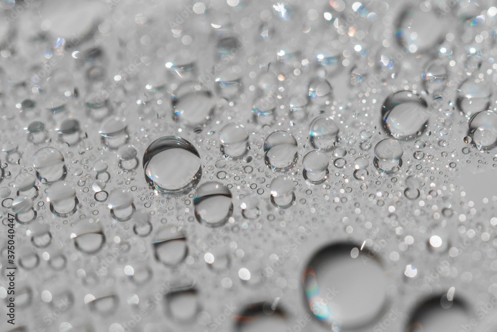 Macro photography of water drops on a mirror reflective surface Macro photography of water drops on a mirror reflective surface