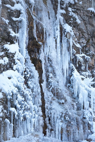 Icicles on the rock. Frozen waterfall in winter.