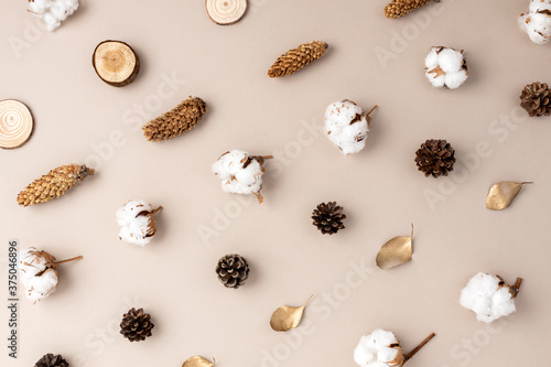 Creative layout of colorful autumn leaves. Flat lay. Season fall concept. Minimal concept made of dry leaves, pine cones and cotton flower on pastel background. Flat lay, top view.