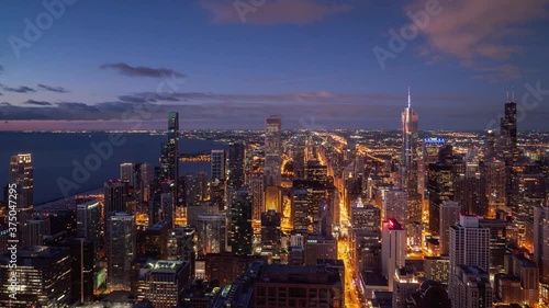 Wallpaper Mural Beautiful night time aerial timelapse of Chicago skyline with pink and blue clouds in the sky floating over the water of Lake Michigan and the high rise skyscrapers in downtown along Michigan Avenue. Torontodigital.ca