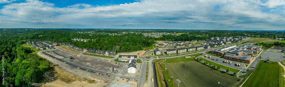 Aerial view of new American town being built in Maryland near Frederick with hundred of single family homes, townhouses, apartment buildings and high school for the population
