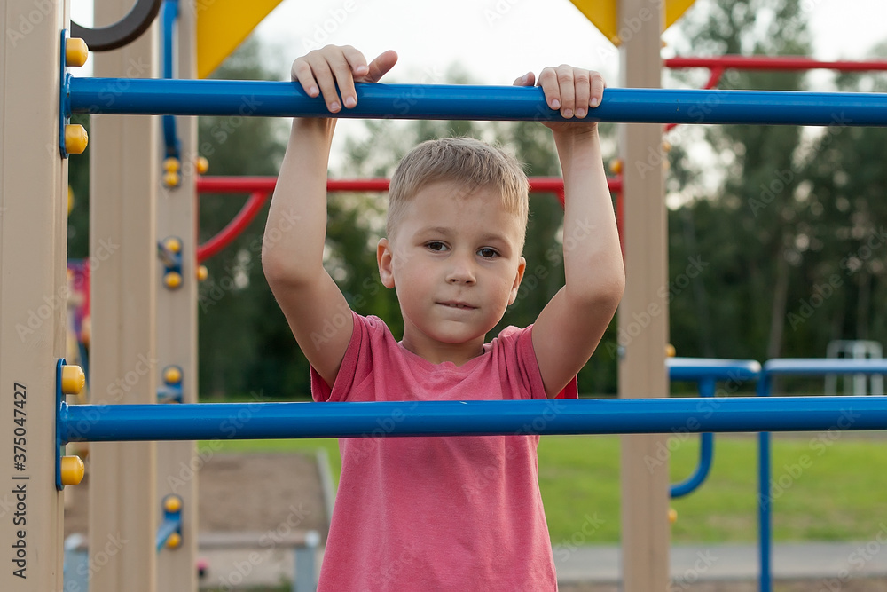 summer, childhood, leisure and people concept-happy child on the Playground. Mobile games summer, childhood, leisure and people concept-happy child on the Playground. Mobile games
