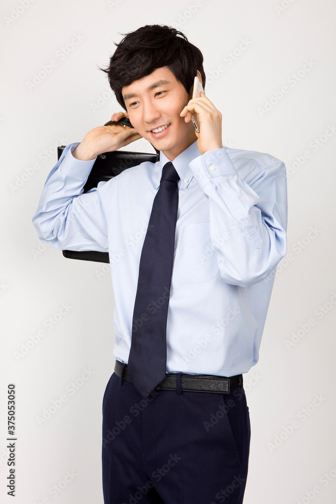 young businessman talking on mobile phone young businessman talking on mobile phone