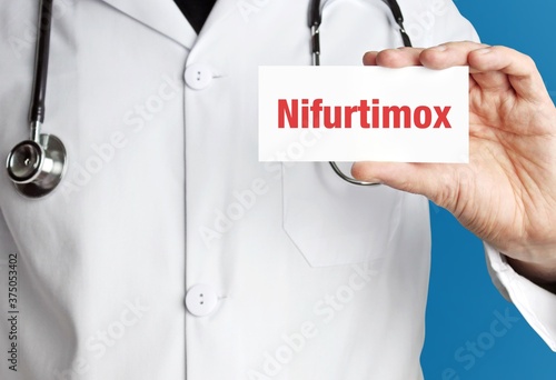 Nifurtimox. Doctor holds a business card in his hand. Text is on the sign. Close up. photo