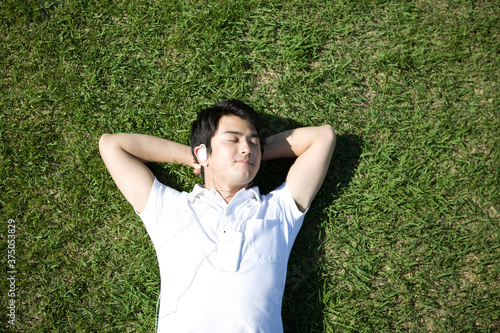 young man lying on grass