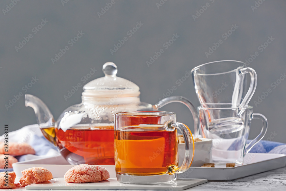 Composition with hot tea and sweets on table Composition with hot tea and sweets on table