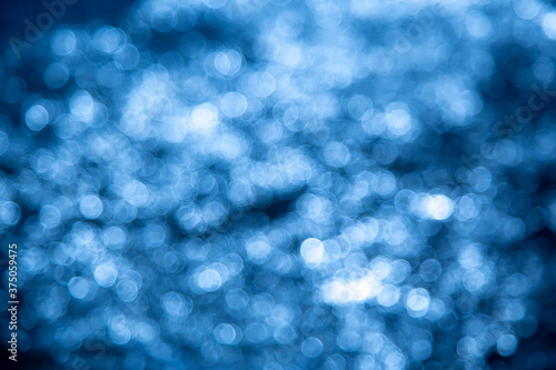 Bokeh of the water reflaction on the sea. Blue bokeh background.