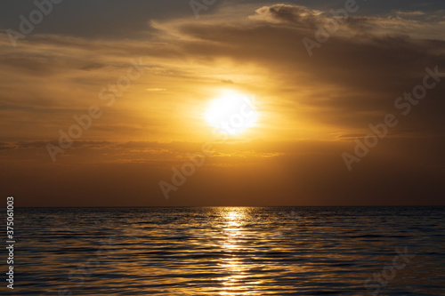 incredibly beautiful golden sunset over the sea for background and screensaver © Dubnytskaya Photo