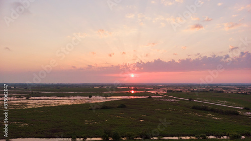 cloudy beautiful soft dawn or sunset, horizontal photo 16: 9, photos from the air, low sun rays pierce low clouds