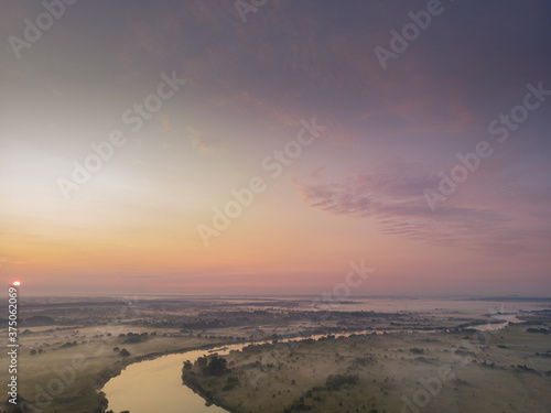 river flooding on the background of a cloudy beautiful soft dawn or sunset, horizontal photo 16:9, photos from the air