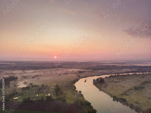 river flooding on the background of a cloudy beautiful soft dawn or sunset, horizontal photo 16:9, photos from the air
