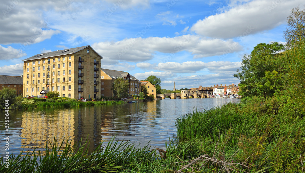 The River Ouse at St Ives  Cambridgeshire with the Old Mill,  historic bridge and river port.