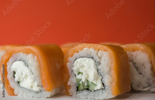 Close-up of philadelphia sushi, fresh japanese food snacks, rice and cucumber in sushi, shallow depth of field, selective focus