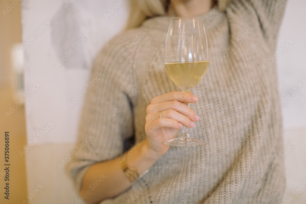 Fototapeta premium Woman drinking white wine at date. Close up.