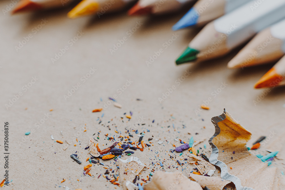 background for art workshop or school class on drawing and fine arts: sharpened colored pencils and shavings on a drawing sheet background for art workshop or school class on drawing and fine arts: sharpened colored pencils and shavings on a drawing sheet