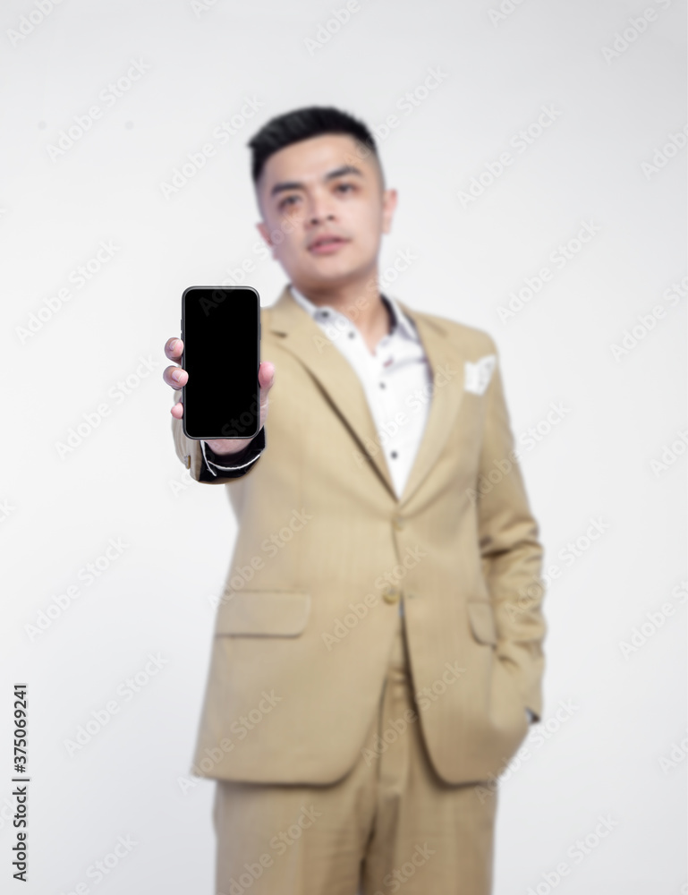 Closeup mobile phone with blurry background businessman isolated on background