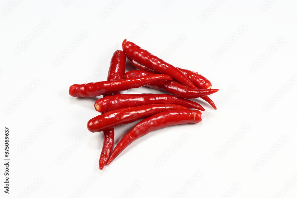Pile of fresh and organic red chilly isolated on the white background. Famous spices herbal in Asia restaurant. Mock up of product concept. Pile of fresh and organic red chilly isolated on the white background. Famous spices herbal in Asia restaurant. Mock up of product concept.