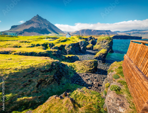 Superb summer view of small fishing village at the foot of Mt. Stapafell - Arnarstapi or Stapi. Bright morning scene of Icelandic countryside. Traveling concept background. photo