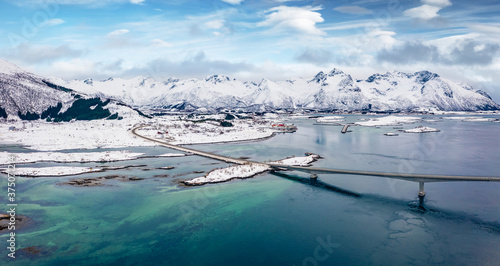 View from flying drone of Gimsoystraumen bridge. Picturesque winter scene of Lofoten Islands, Norway, Europe. Majestic morning seascape of Norwegian sea. Life over polar circle..