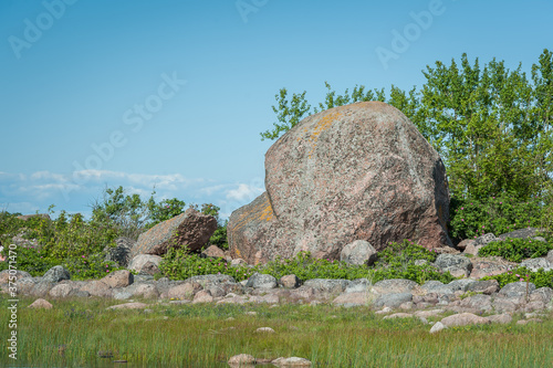 Huge boulder in the shape of a heart. Rocky coastline of the Baltic sea in summer. Purekkari cape, Estonia.