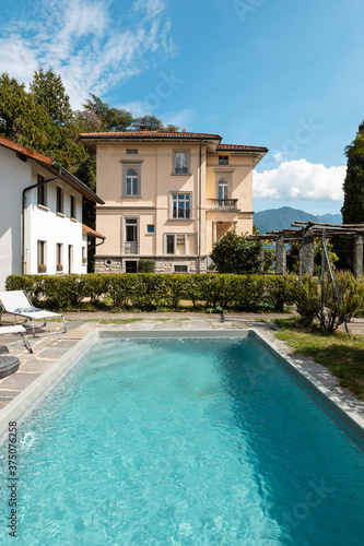 Ancient villa with swimming pool on a sunny summer day © alexandre zveiger