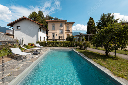 Ancient villa with swimming pool on a sunny summer day © alexandre zveiger