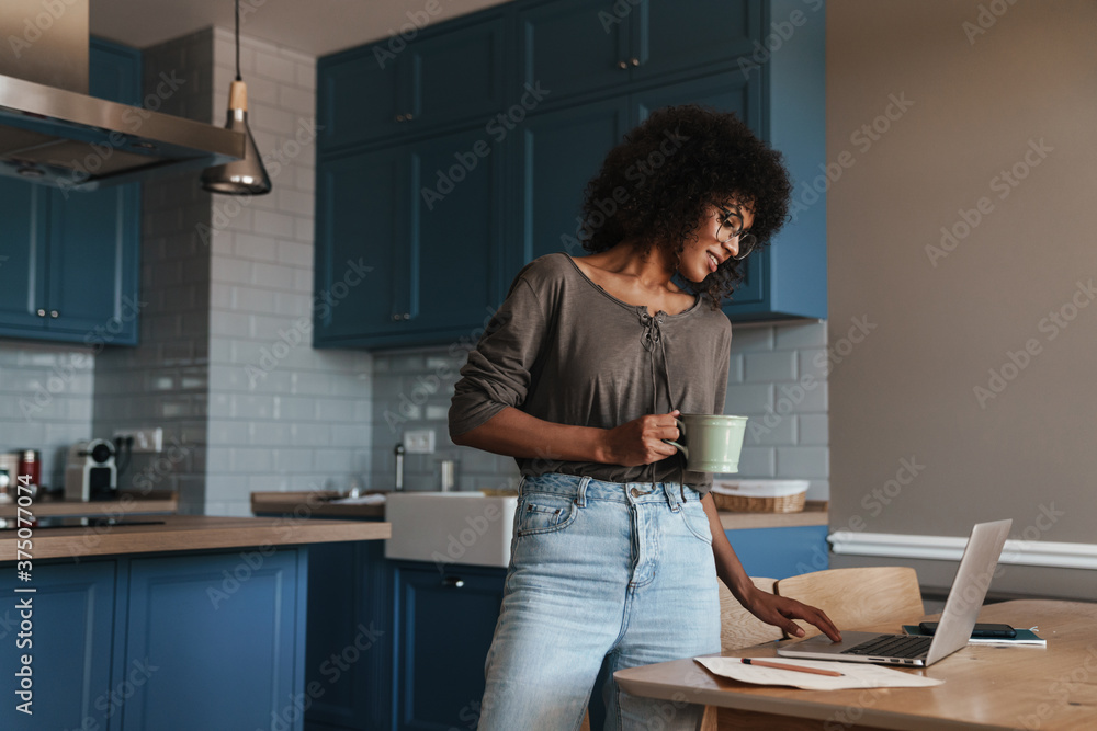Smiling young female entrepreneur working on laptop Smiling young female entrepreneur working on laptop