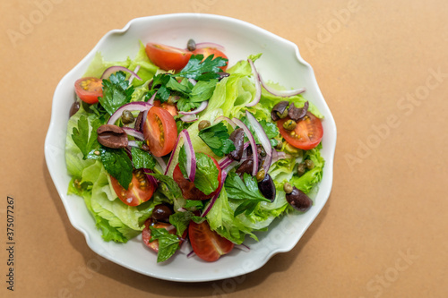 Close up view of the plate with fresh garden salad