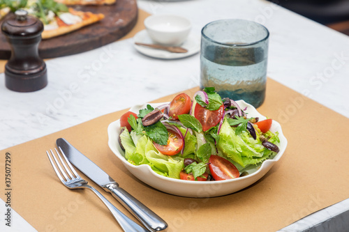 View of plate with fresh garden organic salad, served at a restaurant 
