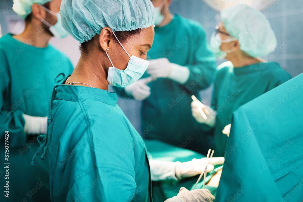 Team surgeon at work in operating room. Team surgeon at work in operating room.