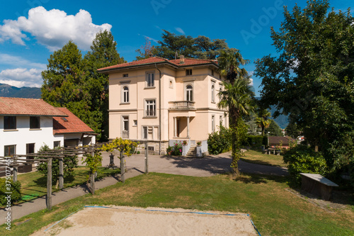 Ancient villa surrounded by nature in the hills in Switzerland. Sunny summer day photo