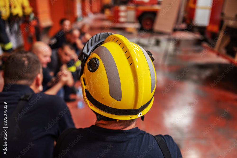 Firemen sitting in circle and taking a break form difficult day. Firemen sitting in circle and taking a break form difficult day.