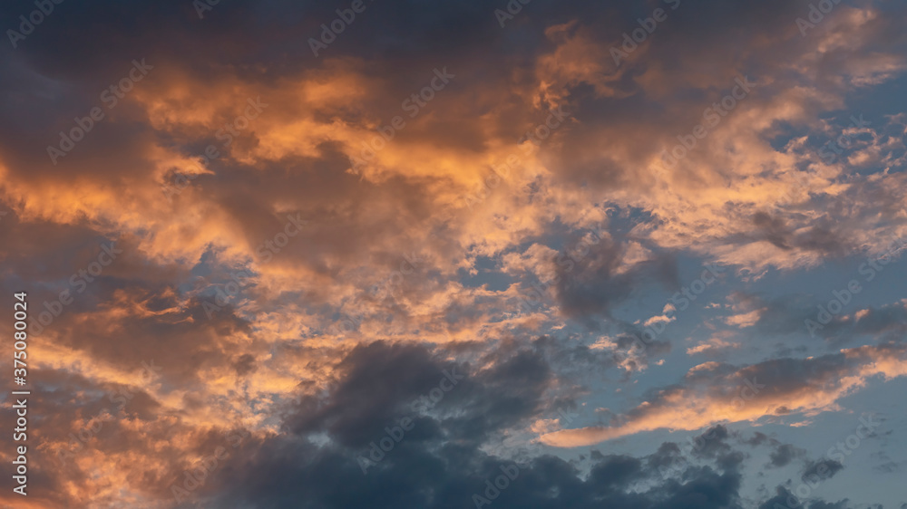 colorful sunset against blue evening sky as natural background