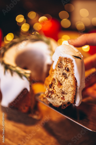 Christmas stollen: holiday pie decorated with rosemary and Christmas decor on the table. Сoncept for postcard, banner, holiday greeting