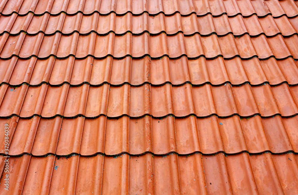 Old roof tiles on the roof of an house as seamless pattern. Red tiles roof texture architecture background, detail of house close up. Old roof tiles on the roof of an house as seamless pattern. Red tiles roof texture architecture background, detail of house close up.