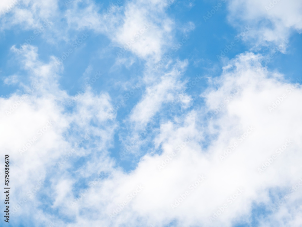White clouds on a blue sky background.