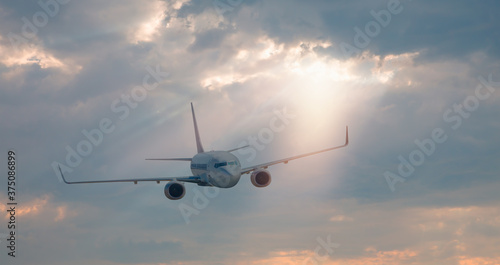 White passenger airplane in the clouds - Travel by air transport