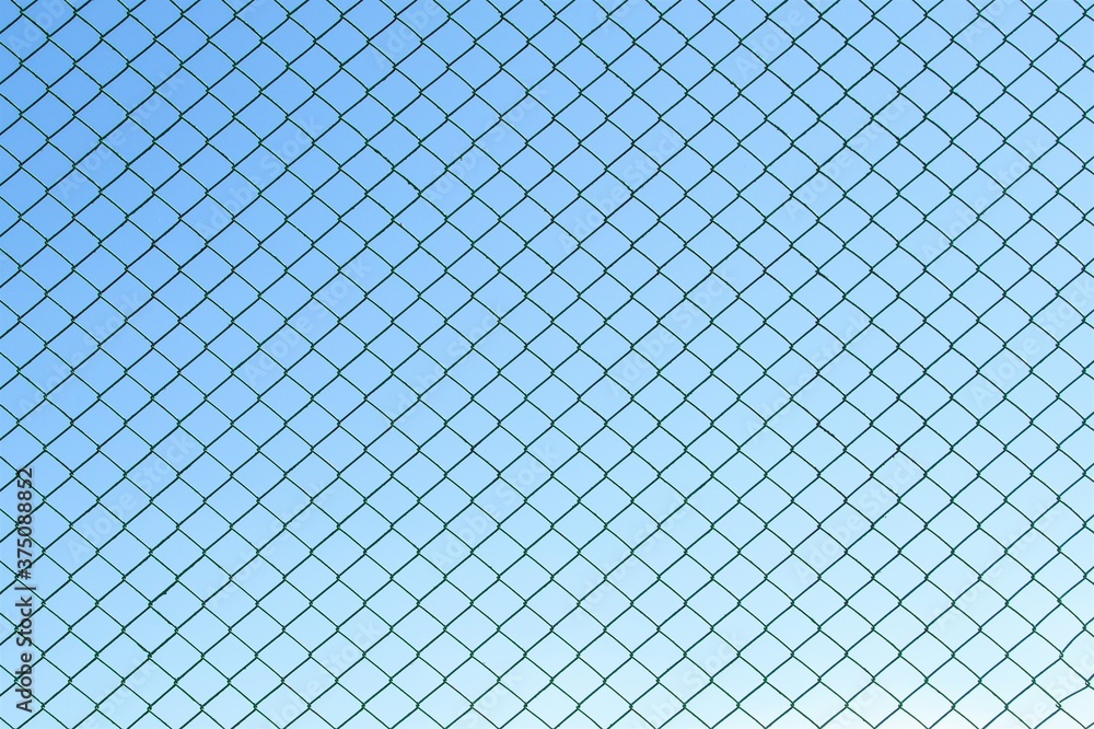 Metallic green mesh against the sky. Metallic green mesh against the sky.